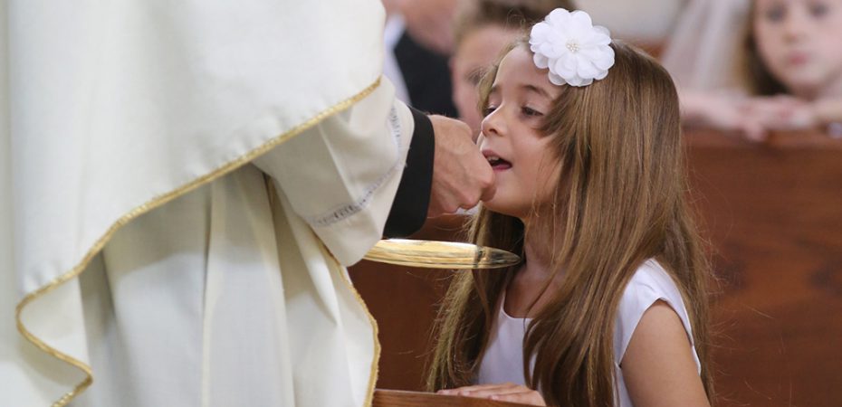 Girl receives first Communion at Maryland church